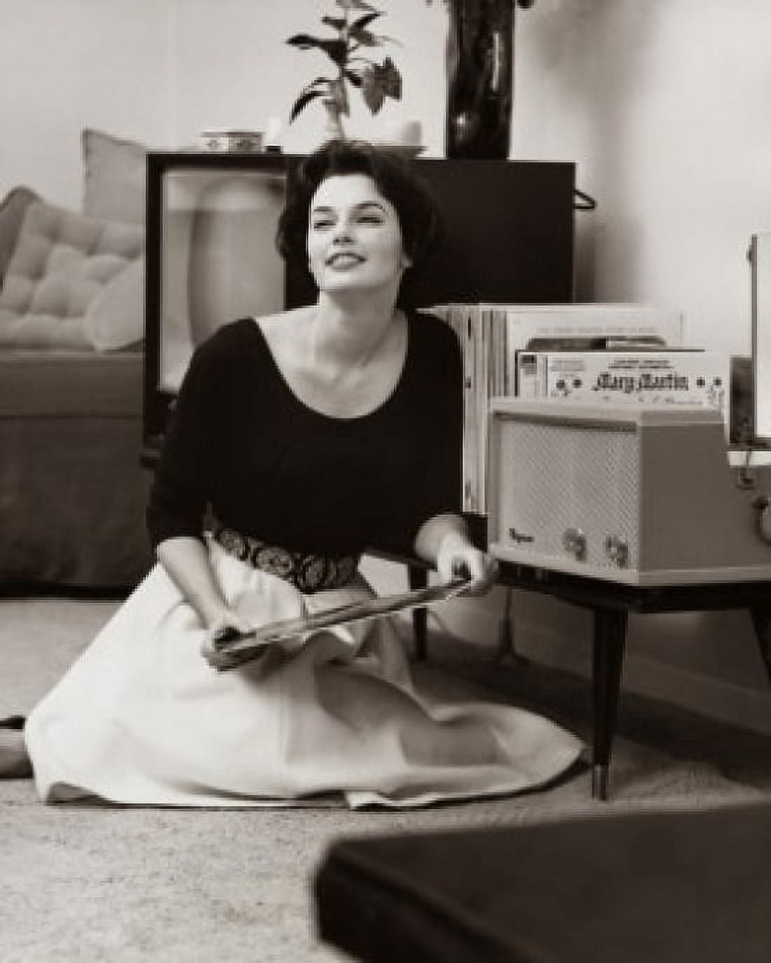 Posterazzi Young woman holding a record sitting on the floor Canvas Art - (24 x 36)