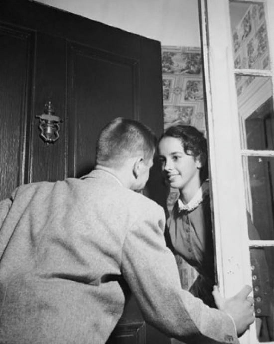 Posterazzi Young woman opening the front door for her date Canvas Art - (24 x 36)