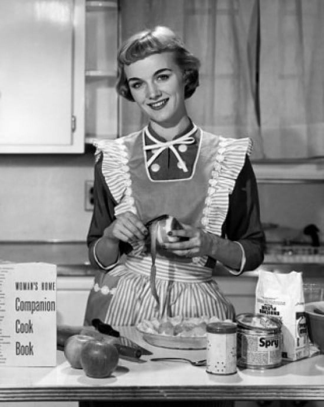 Posterazzi Young woman peeling apple in domestic kitchen Canvas Art - (24 x 36)