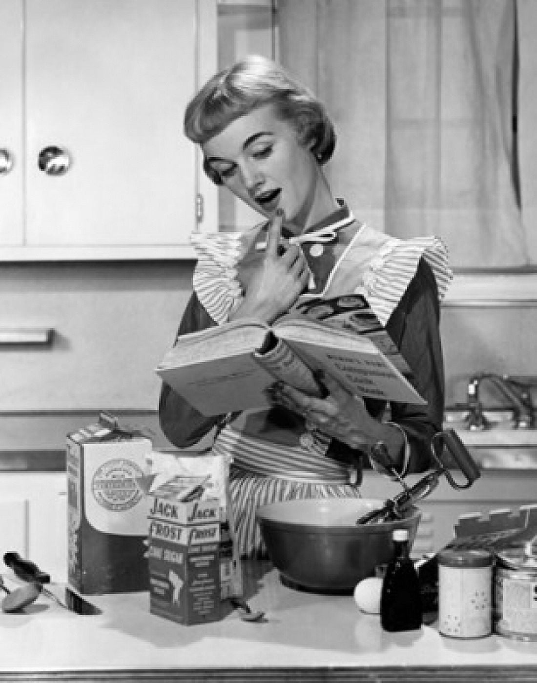 Posterazzi Young woman reading a cookbook in a domestic kitchen Canvas Art - (24 x 36)