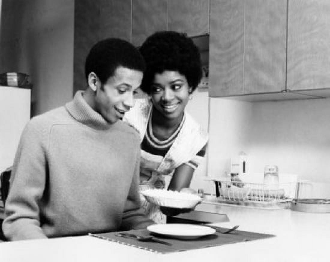 Posterazzi Young woman serving food to a young man Canvas Art -  (24 x 36)