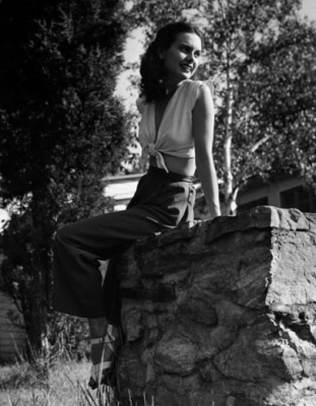 Posterazzi Young woman sitting on a rock and smiling Canvas Art - (24 x 36)
