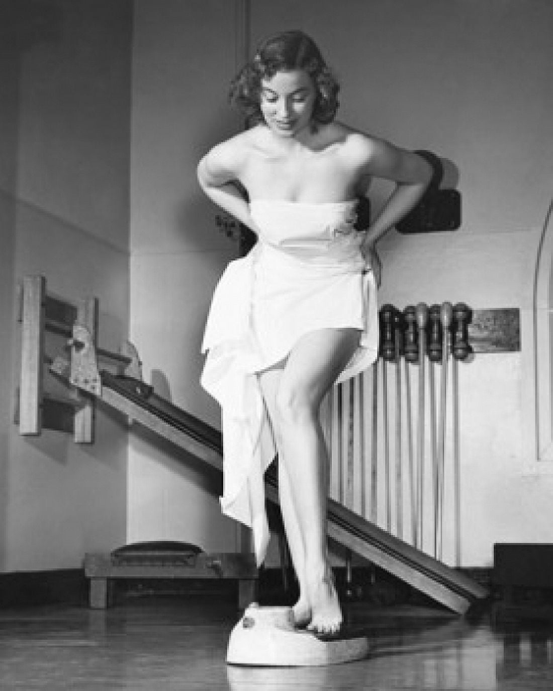 Posterazzi Young woman standing on a weight scale in a gym Canvas Art - (24 x 36)