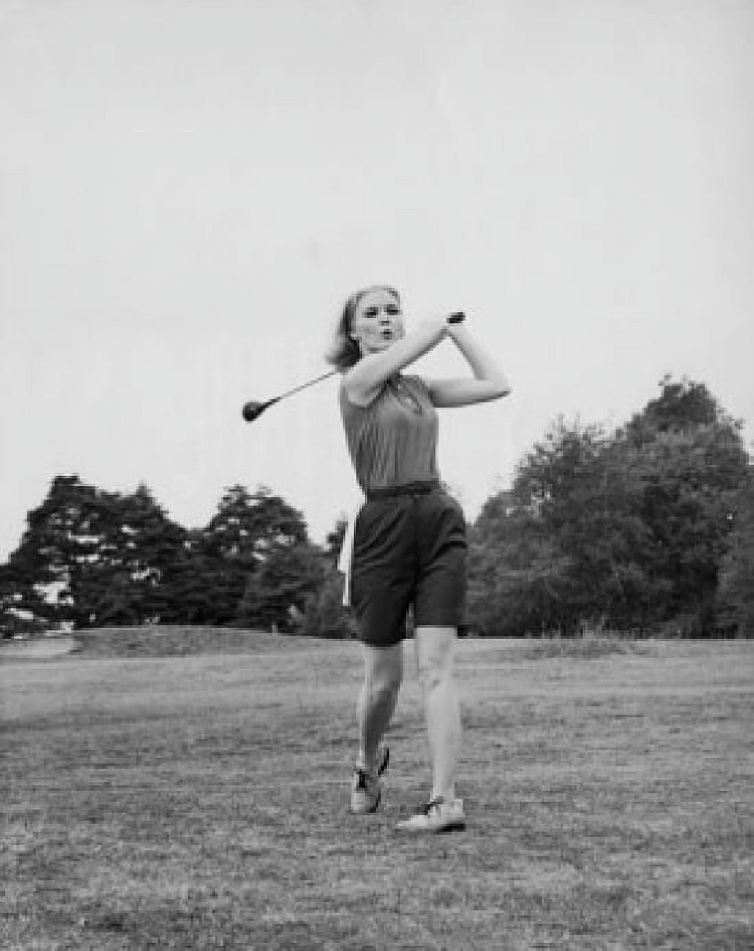 Posterazzi Young woman swinging golf club on golf course Canvas Art - (24 x 36)