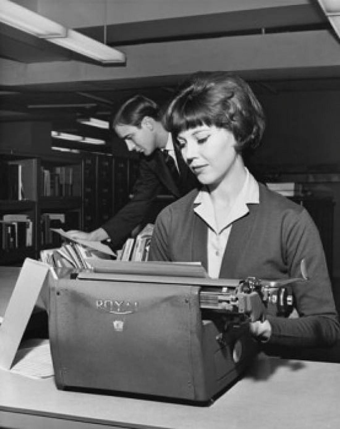 Posterazzi Young woman typing a document on a typewriter in an office Canvas Art - (24 x 36)