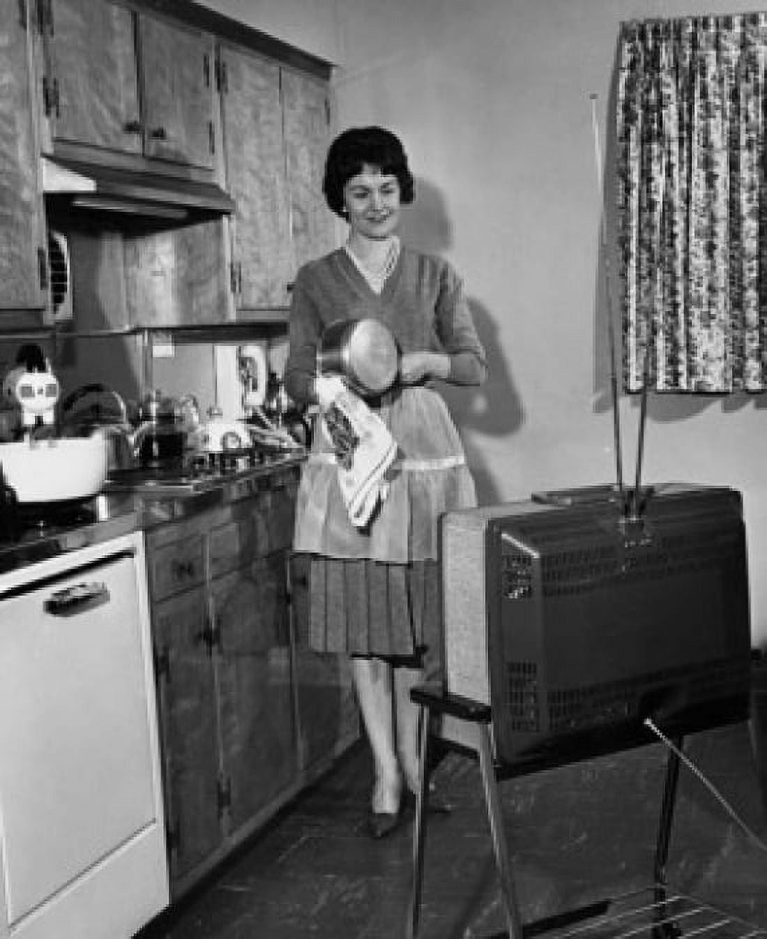 Posterazzi Young woman watching television in kitchen Canvas Art -  (24 x 36)