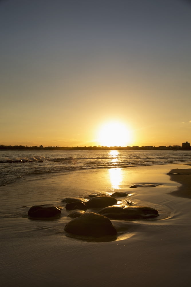 Posterazzi A golden sun sets over the horizon and reflects on the wet beach along the coast Caloundra Queensland Australia Canvas Art - John Short Design Pics (24 x 38)