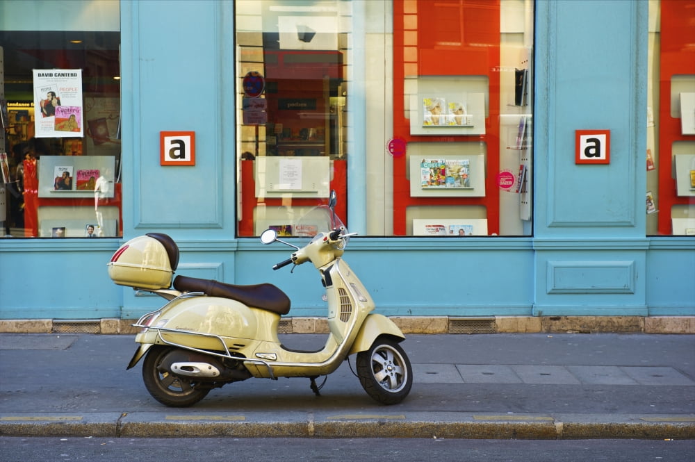 Posterazzi A motorized scooter parked outside a blue building along a street Canal Saint Martin Paris France Canvas Art - Ingrid Rasmussen Design Pics (38 x 24)