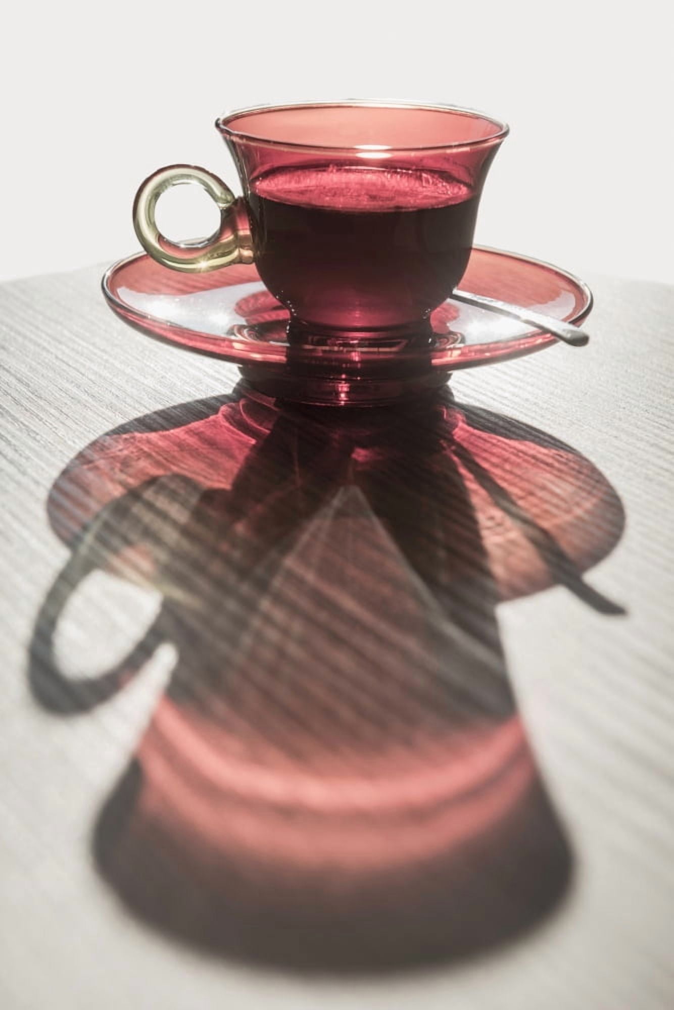 Posterazzi A red glass cup a saucer with a beverage reflected on a white surface Locarno Ticino Switzerland Canvas Art - Mats Silvan Design Pics (24 x 38)