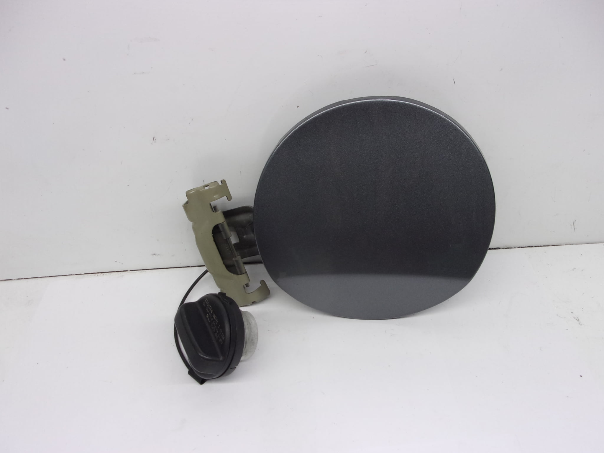 Pre-Owned 2017 Nissan Versa Fuel Filler Door Gas Tank Door OEM - Verify Specific Vehicle Fitment In Description - (Good)