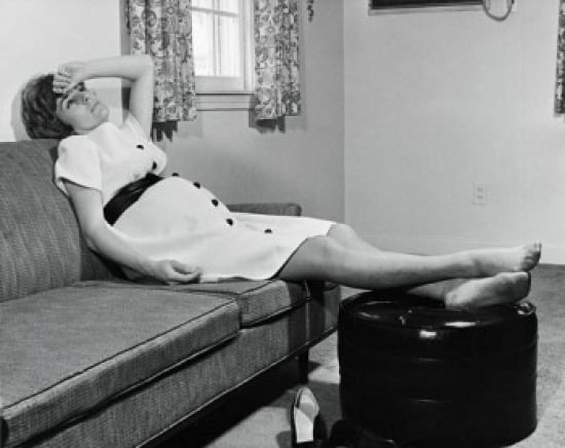 Pregnant woman sitting on a couch Canvas Art - (24 x 36)