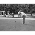 thumbnail image 1 of President Dwight Eisenhower On A Putting Green Of A Golf Course. August 1957. African American Caddies Watch From The, 1 of 2