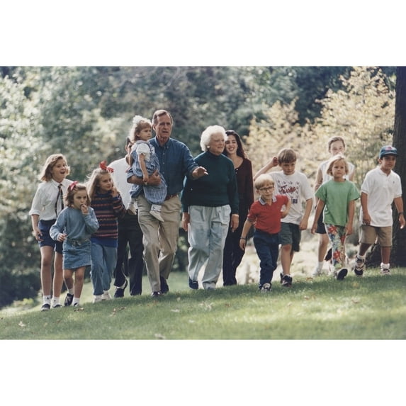 President George H. W. Bush And Wife Barbara Walk With Eleven Of Their Grandchildren At The Presidential Retreat Camp