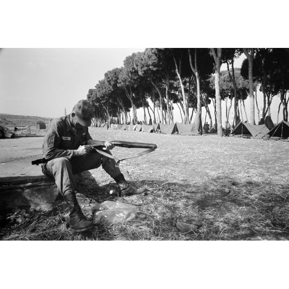 Print: American Paratrooper Cleans His Gun At Army Base Camp In Beirut