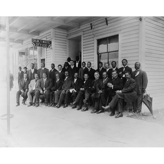 Print: Booker T. Washington Seated With Group Of Men Outside The Office Of