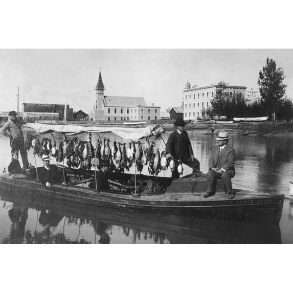 Print: Marshall Erwin In Front Of A Boat Containing A Kill Of Ducks, circa