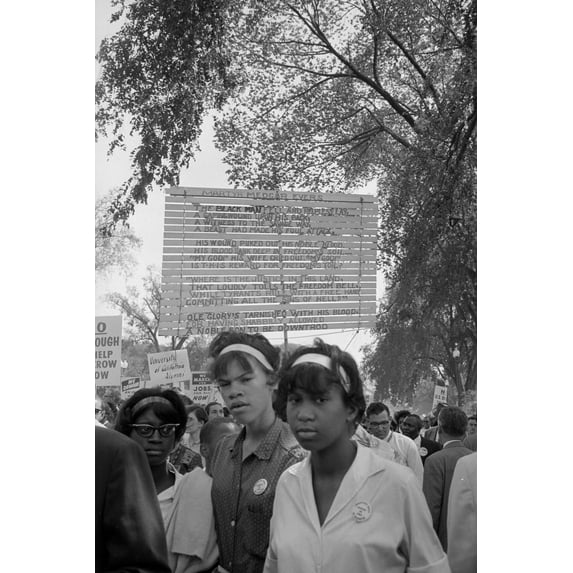 Print: Young Women With Signs Raised Behind Them At The March On