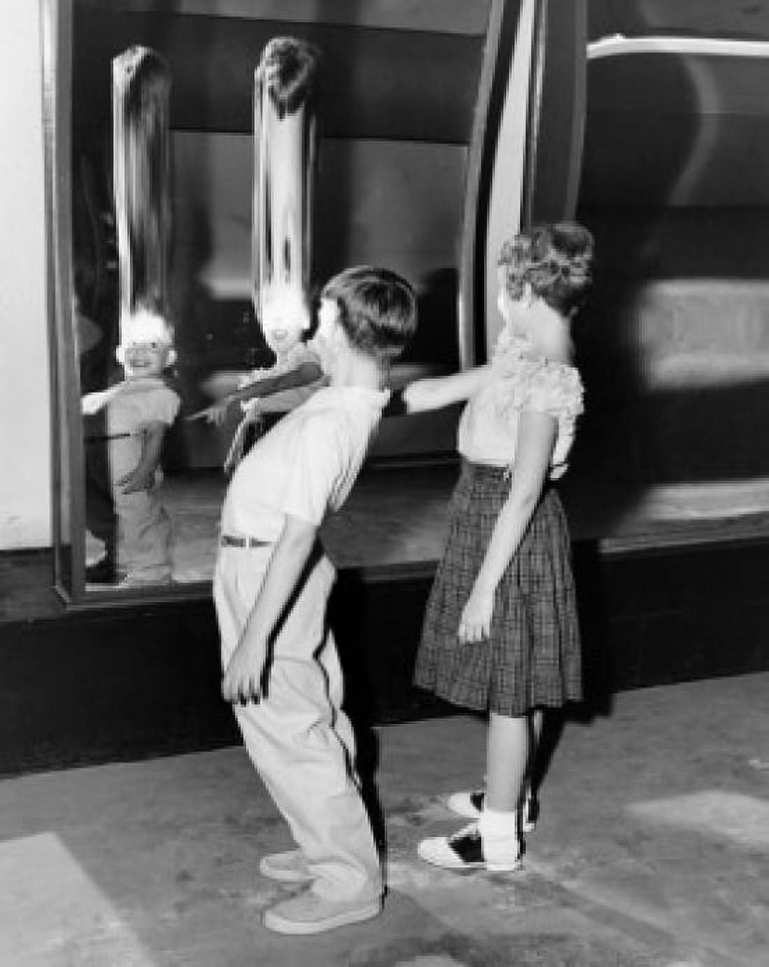 Profile of boy and girl looking in fun house mirror Canvas Art - (24 x 36)