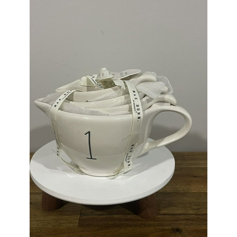 https://i5.walmartimages.com/seo/Rae-Dunn-Measuring-Cup-set-Ivory-Ceramic-includes-1-cup-1-2-cup-1-3-cup-1-4-cup-handles-Black-LL-letters_2ce602a2-28aa-4b7d-883d-492995c021cc.938af4ebc307a5f97f44d6fe7d18ad6c.jpeg?odnHeight=768&odnWidth=768&odnBg=FFFFFF