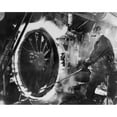 thumbnail image 1 of Railroad Worker Sweating A Tire On A Locomotive Wheel. This Is The Process Of Heating The Circular Metal 'Tire History, 1 of 1