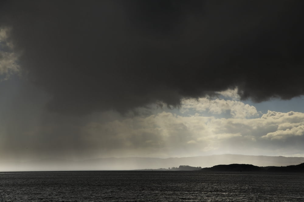 Rain falling from ominous dark clouds over the water Otter Ferry Scotland Canvas Art - John Short Design Pics (19 x 12)