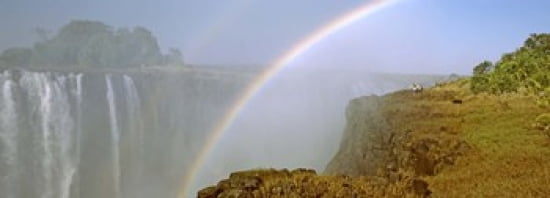Rainbow form in the spray created by the water cascading over the Victoria Falls Zimbabwe Canvas Art - Panoramic Images (36 x 13)