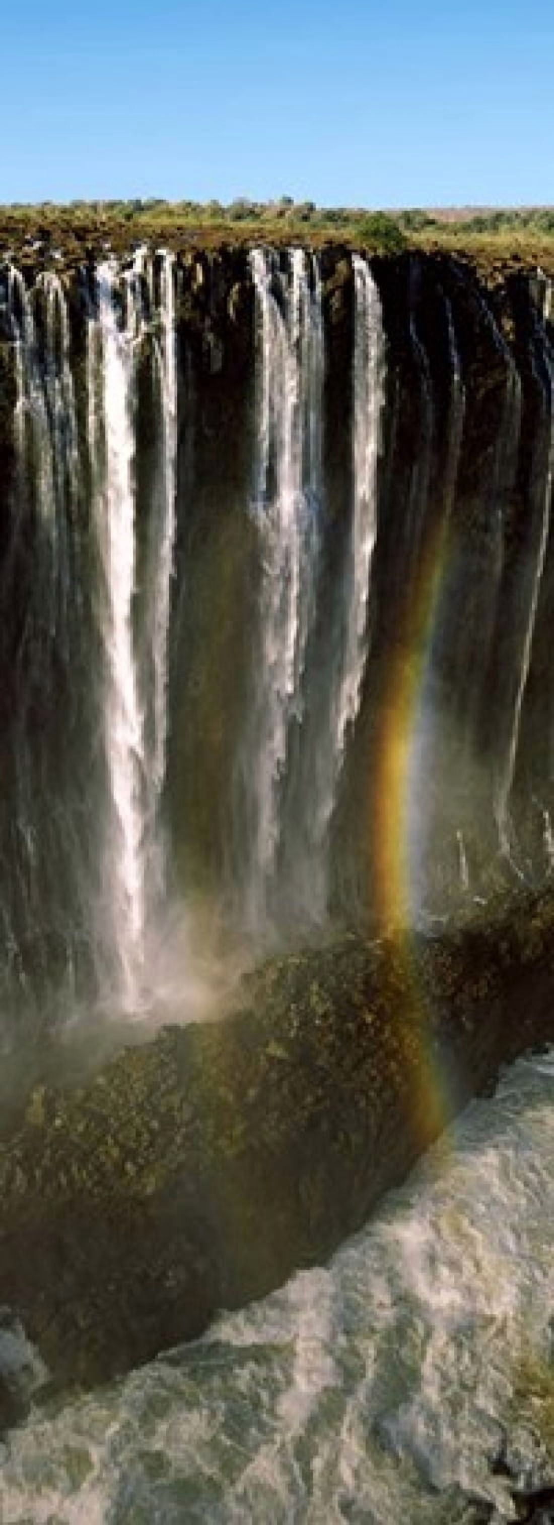 Rainbow forms in the water spray in the gorge at Victoria Falls Zimbabwe Canvas Art - Panoramic Images (36 x 13)