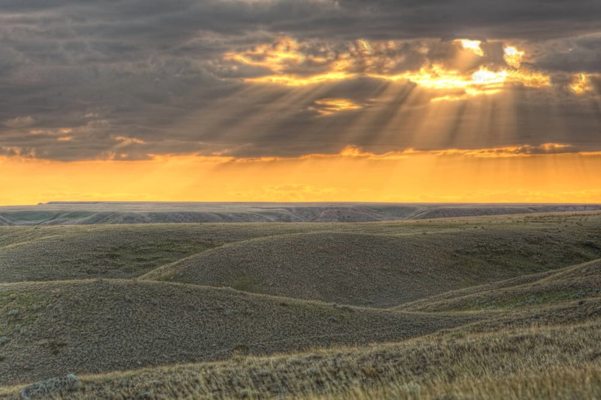 Rays Of Sunset Light Between The Clouds Grasslands National Park Saskatchewan Canvas Art - Robert Postma Design Pics (17 x 11)