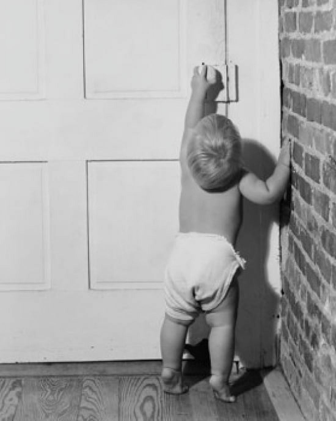 Rear view of a baby opening a door Canvas Art - (18 x 24)