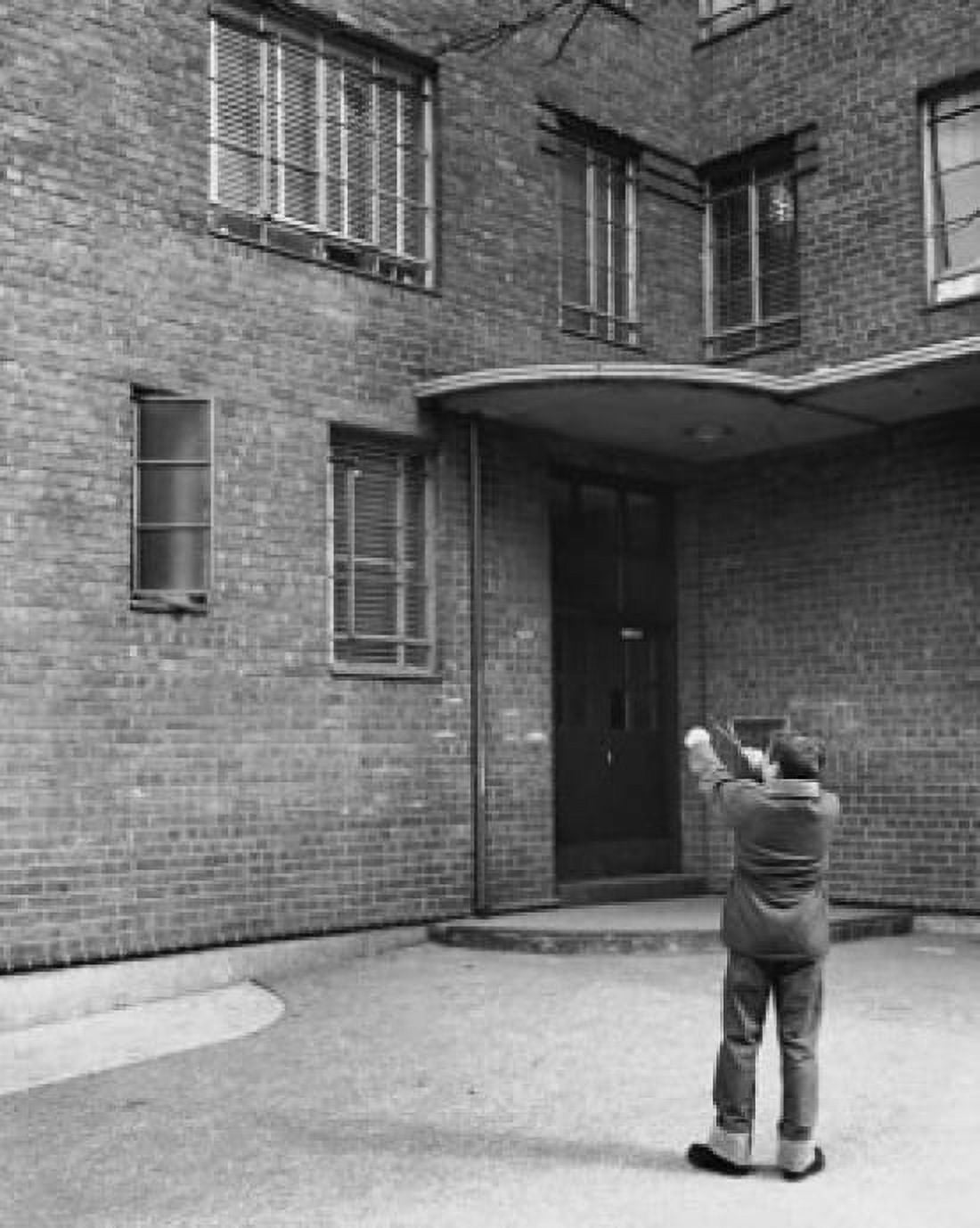 Rear view of a boy aiming at windows with a slingshot Canvas Art - (18 x 24)