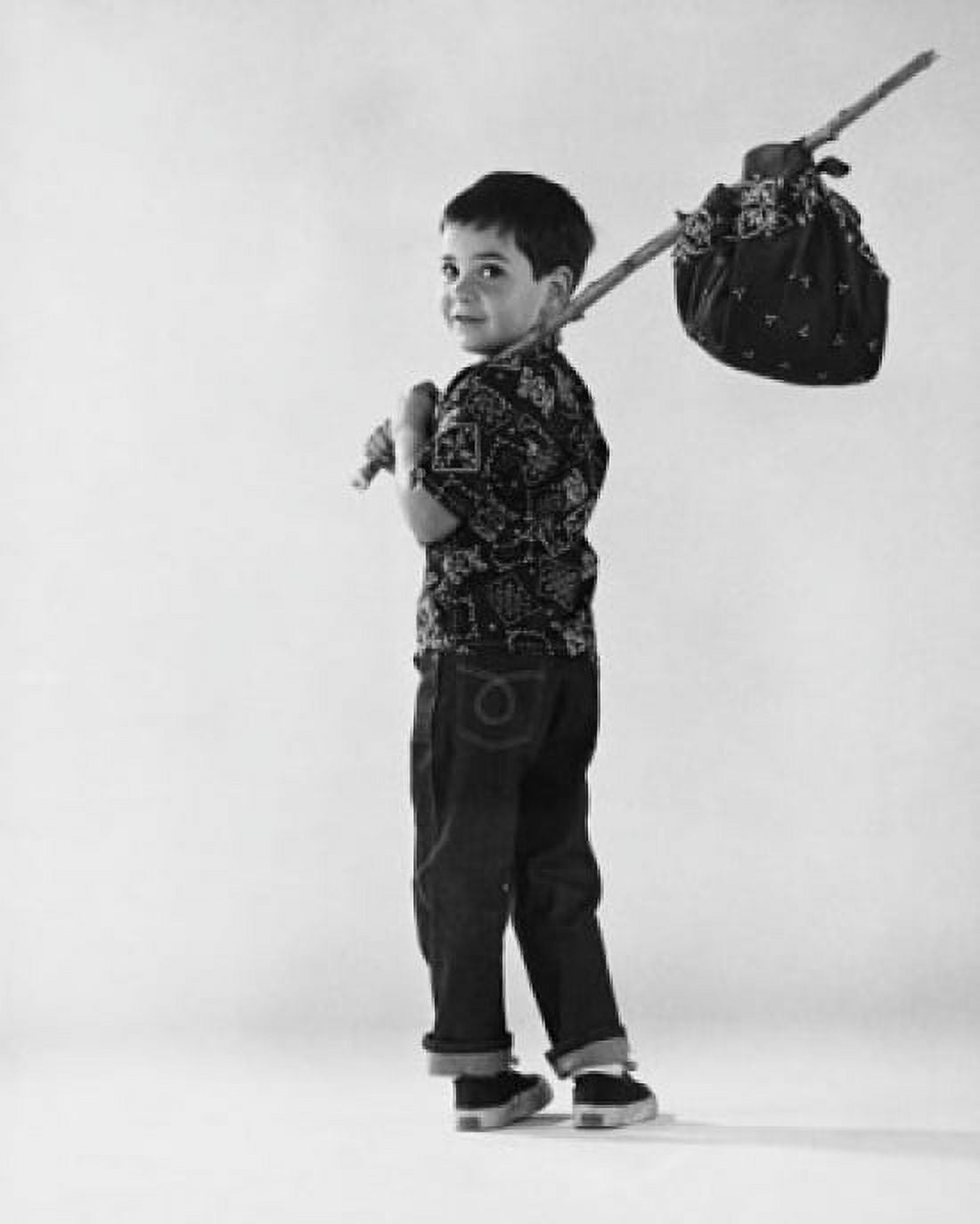 Rear view of a boy carrying a bundle on a stick Canvas Art - (24 x 36)