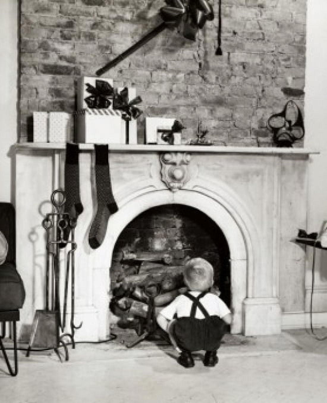 Rear view of a boy crouching near a fireplace Canvas Art - (24 x 36)