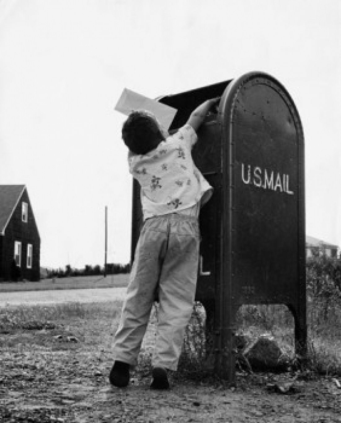 Rear view of a boy dropping mail in a mailbox Canvas Art - (18 x 24)