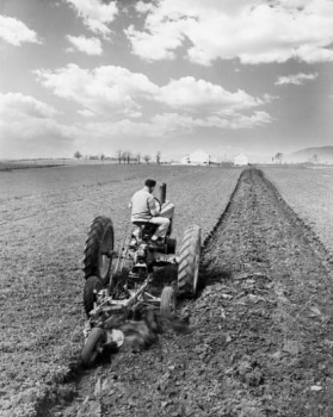 Rear view of a farmer plowing a field with a tractor Canvas Art - (18 x 24)