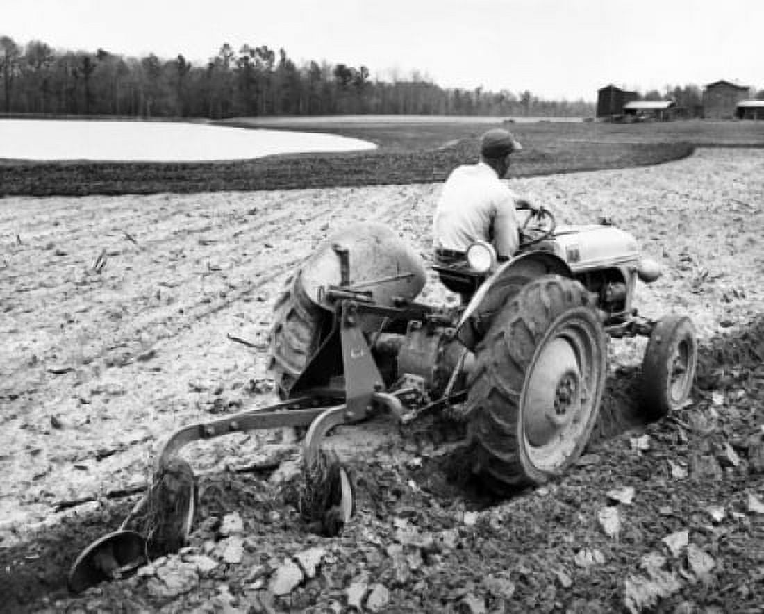 Rear view of a farmer plowing a field with a tractor Canvas Art - (24 x 36)