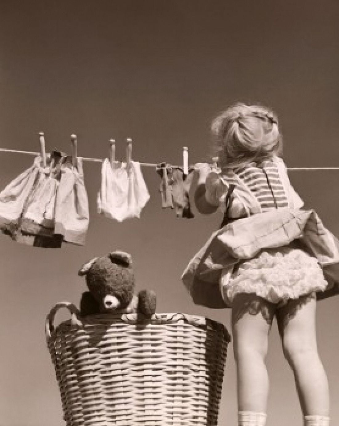 Rear view of a girl hanging clothes on a clothes line Canvas Art - (18 x 24)