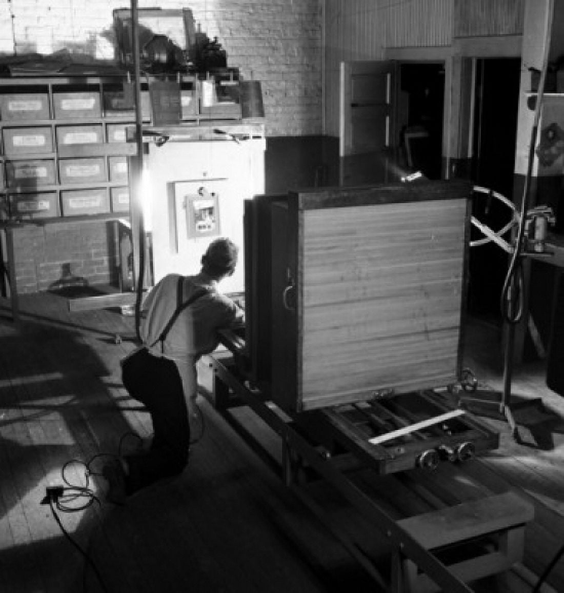 Rear view of a male worker operating a photoengraving camera Canvas Art -  (24 x 36)