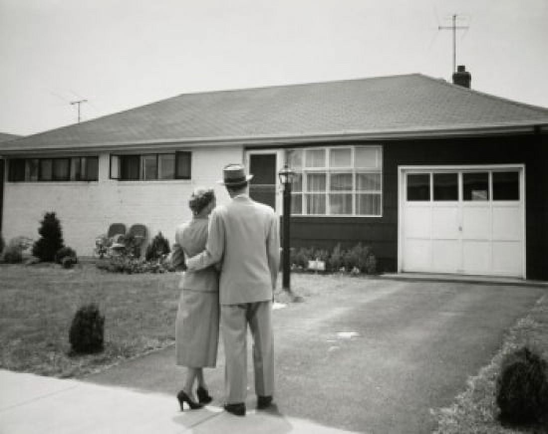 Rear view of a man and a woman standing in front of a house Canvas Art - (18 x 24)