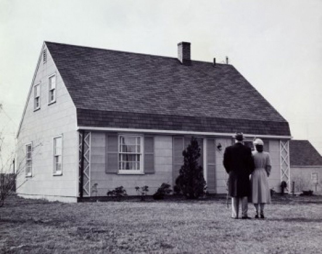 Rear view of a man and a woman standing in front of a house Canvas Art - (18 x 24)