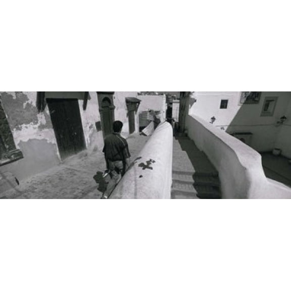 Rear view of a man walking in front of a building Casaba Algiers Algeria Canvas Art - Panoramic Images (18 x 7)