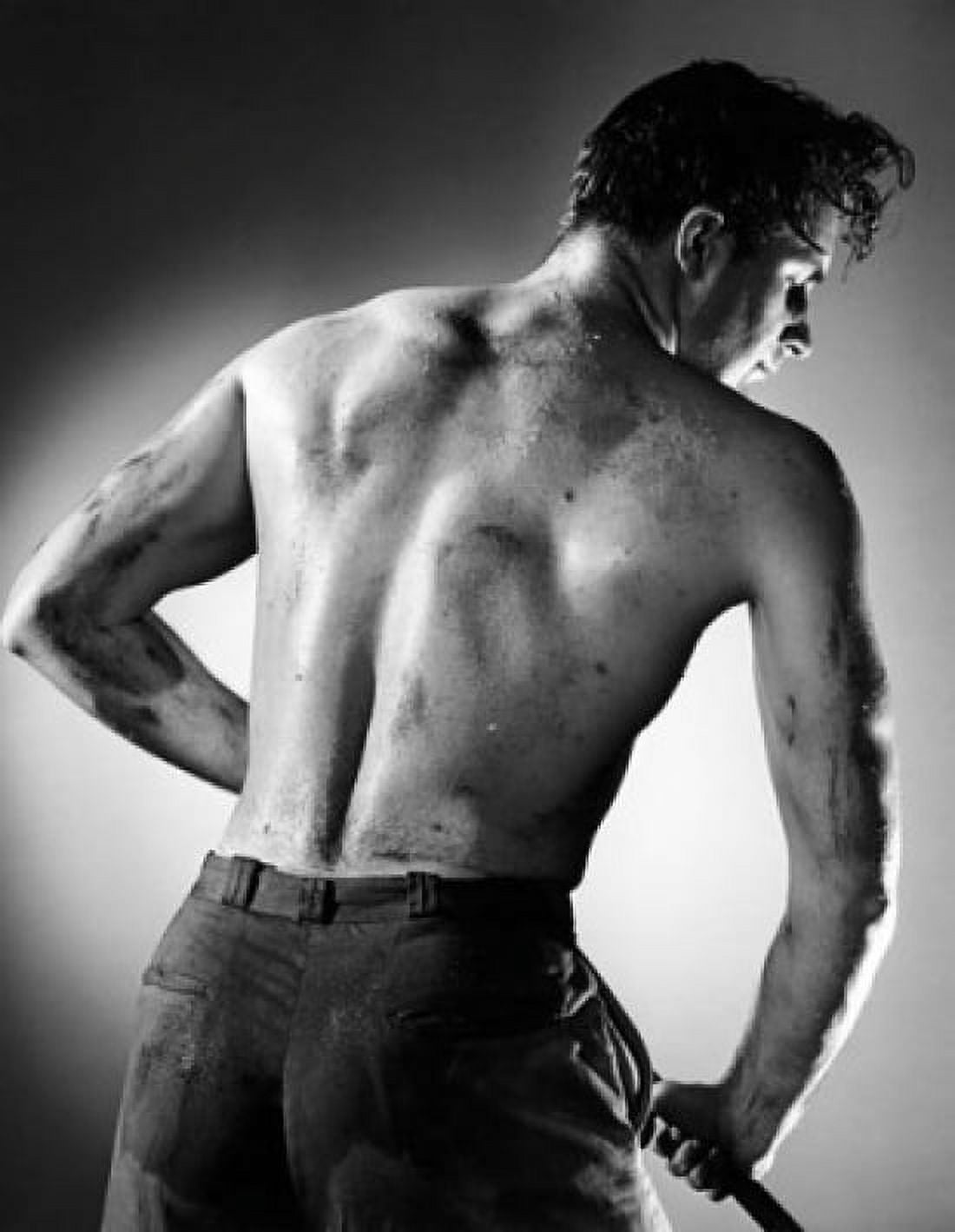 Rear view of a manual worker holding a rod Canvas Art - (18 x 24)