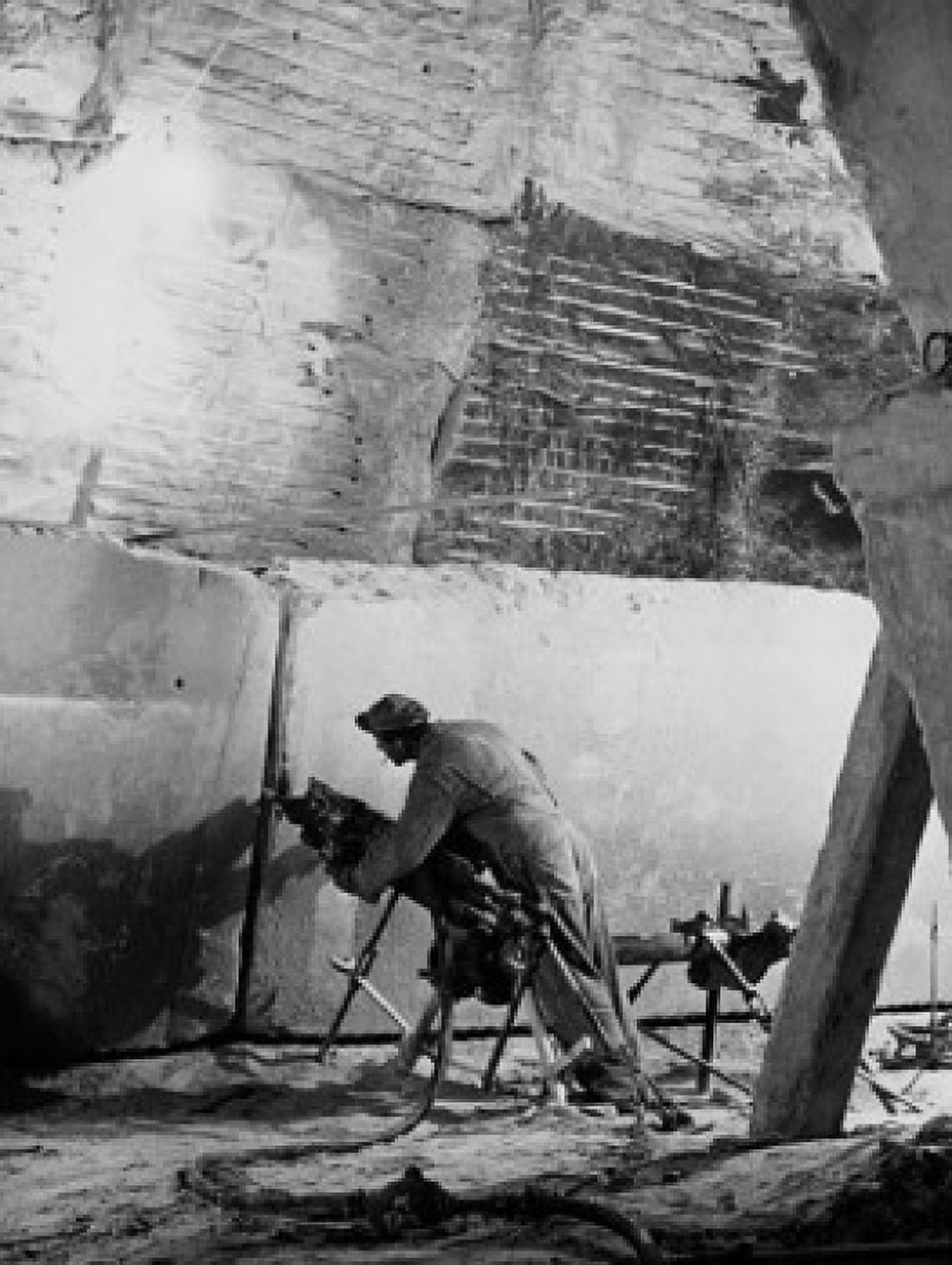 Rear view of a manual worker using a pneumatic saw to cut marble in a quarry Canvas Art - (18 x 24)