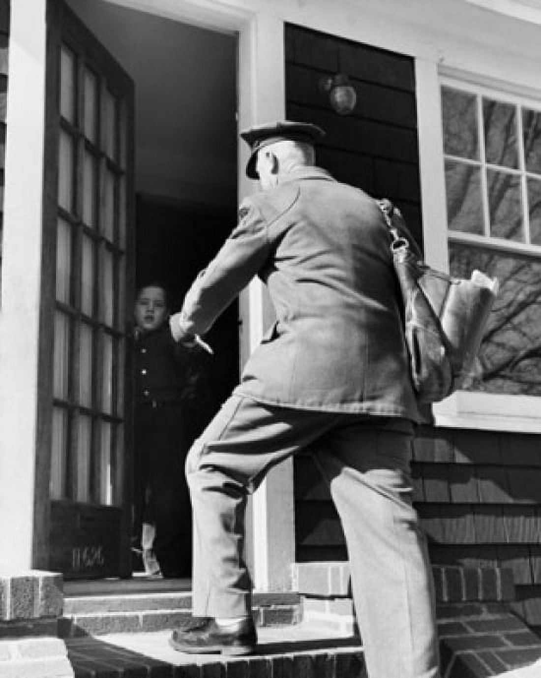 Rear view of a postman giving mail to a boy Canvas Art - (24 x 36)