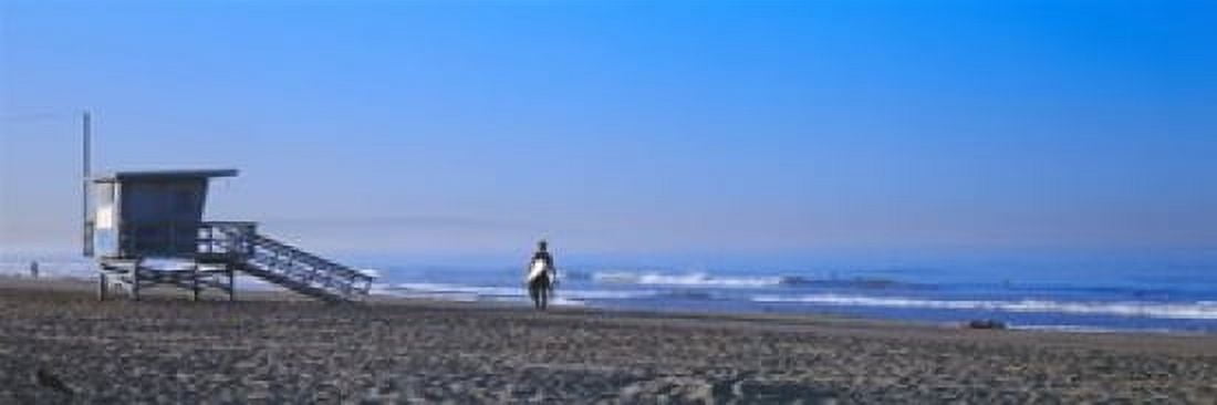 Rear view of a surfer on the beach Santa Monica Los Angeles County California USA Canvas Art - Panoramic Images (18 x 6)