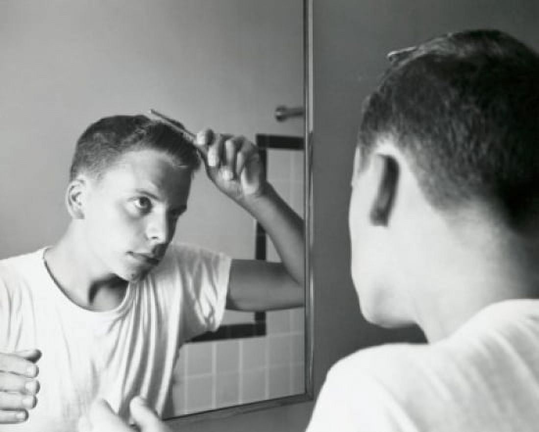 Rear view of a teenage boy combing his hair in front of a mirror 1960 Canvas Art - (18 x 24)