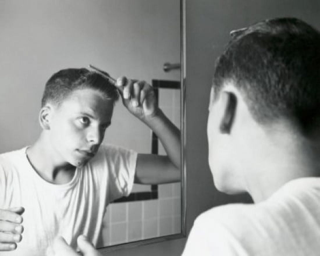 Rear view of a teenage boy combing his hair in front of a mirror 1960 Canvas Art - (24 x 36)