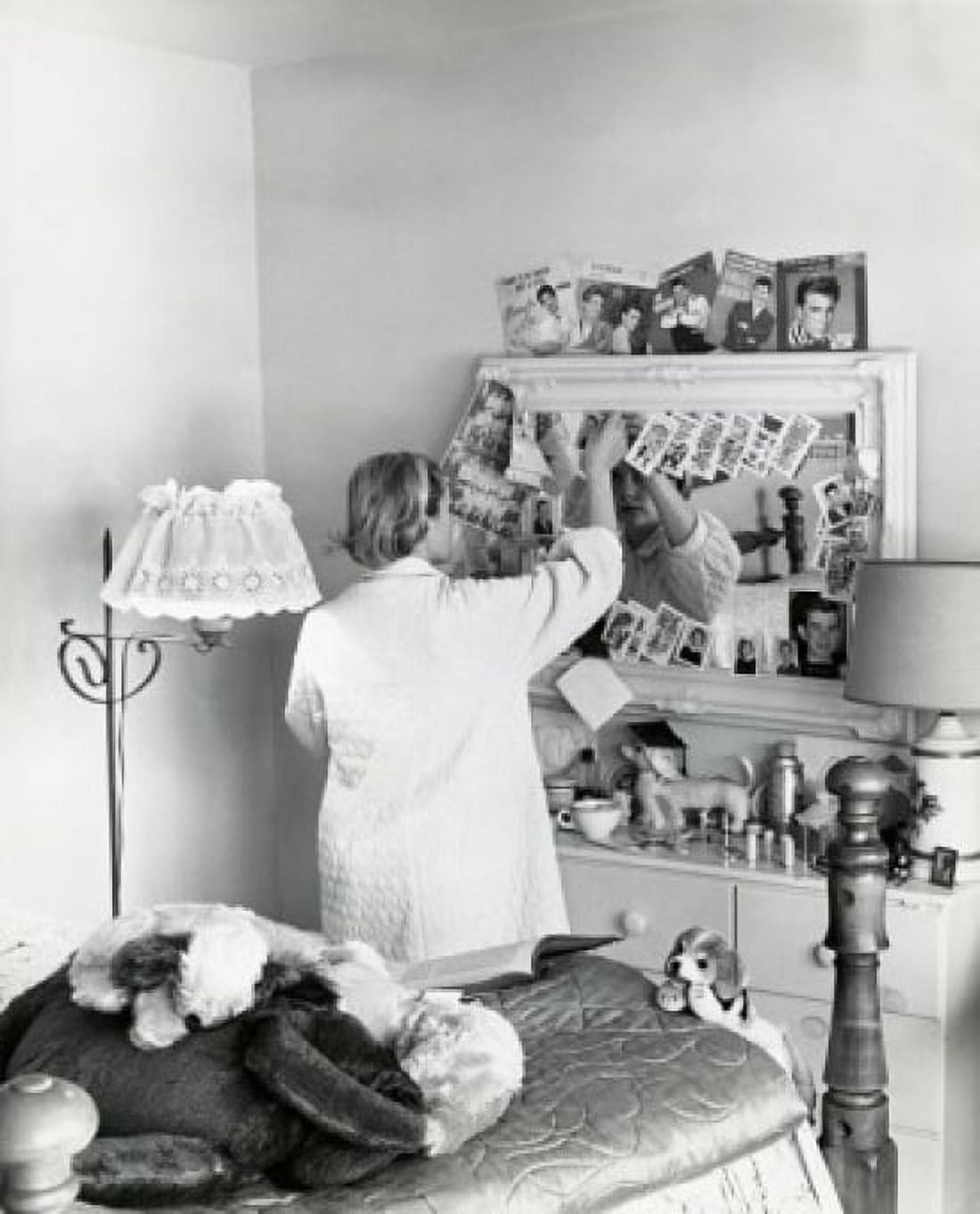 Rear view of a teenage girl standing in front of a mirror in a bedroom 1961 Canvas Art - (24 x 36)