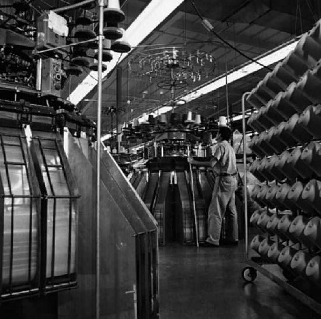 Rear view of a worker working on a machine in a textile factory Canvas Art - (24 x 36)