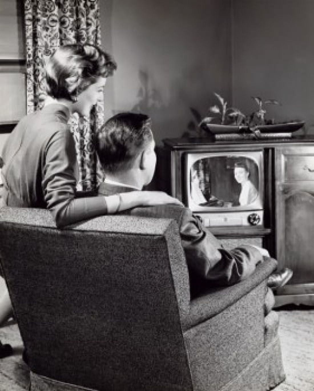 Rear view of a young couple watching a television Canvas Art - (18 x 24)