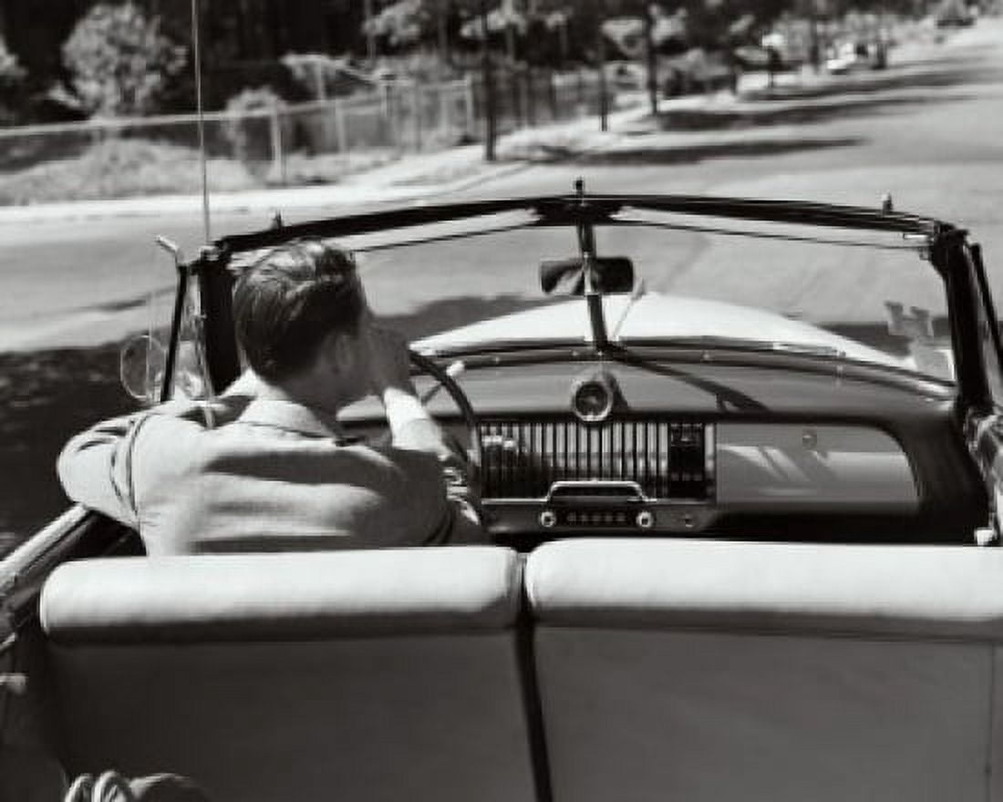 Rear view of a young man driving a convertible car Canvas Art - (18 x 24)